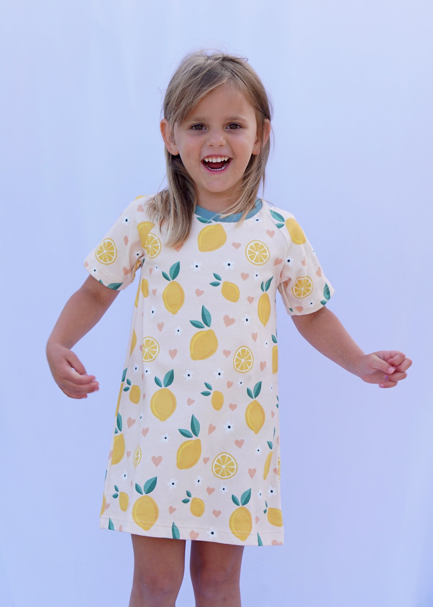 Young girl posing with dress with lemons and hearts